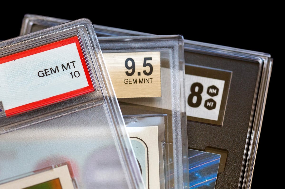 Professionally graded PSA trading cards displayed on a black background