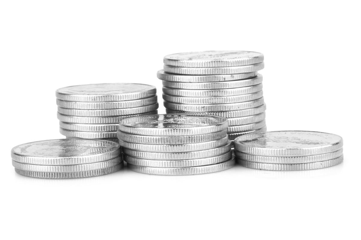 Silver coins arranged together on a light surface