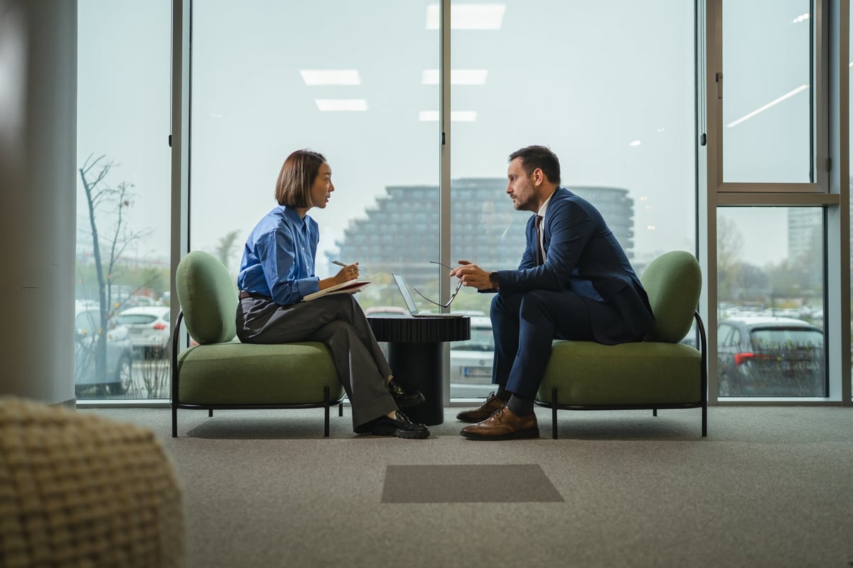 Colleagues in a focused meeting taking notes